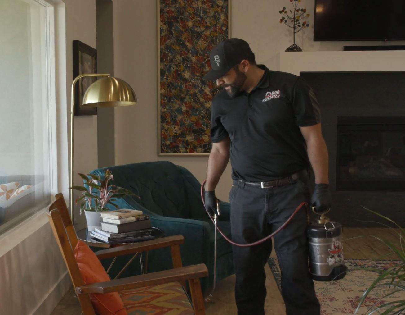 technician in home spraying