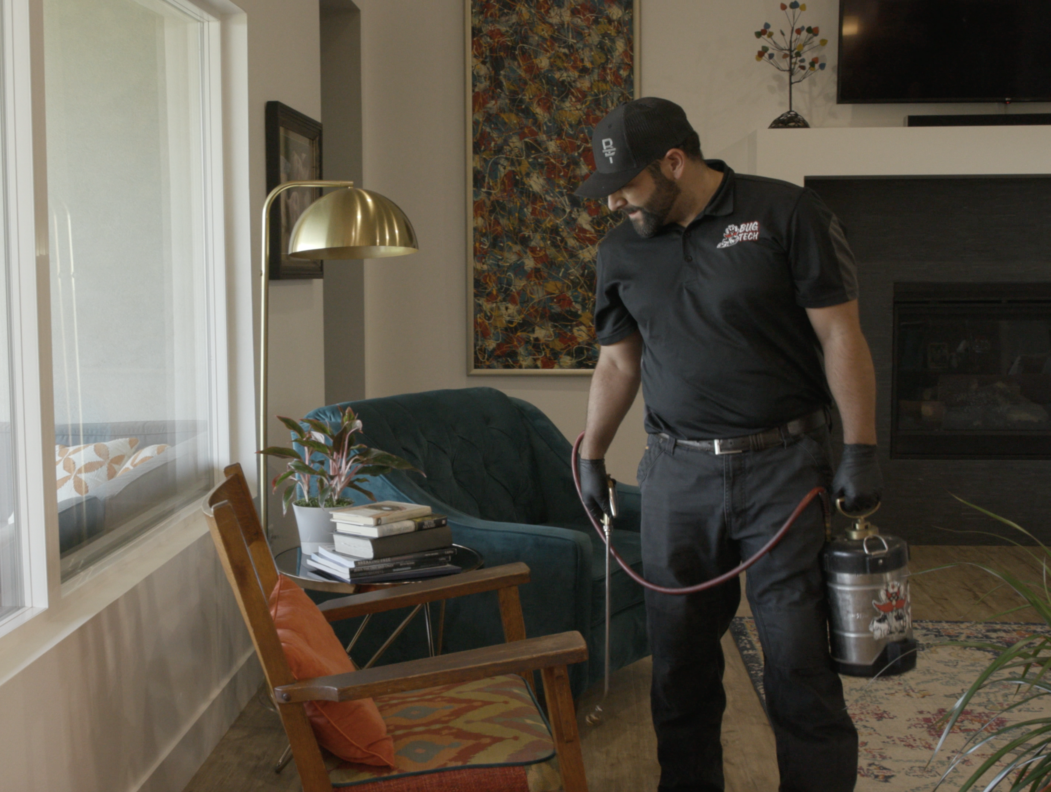 technician in home spraying