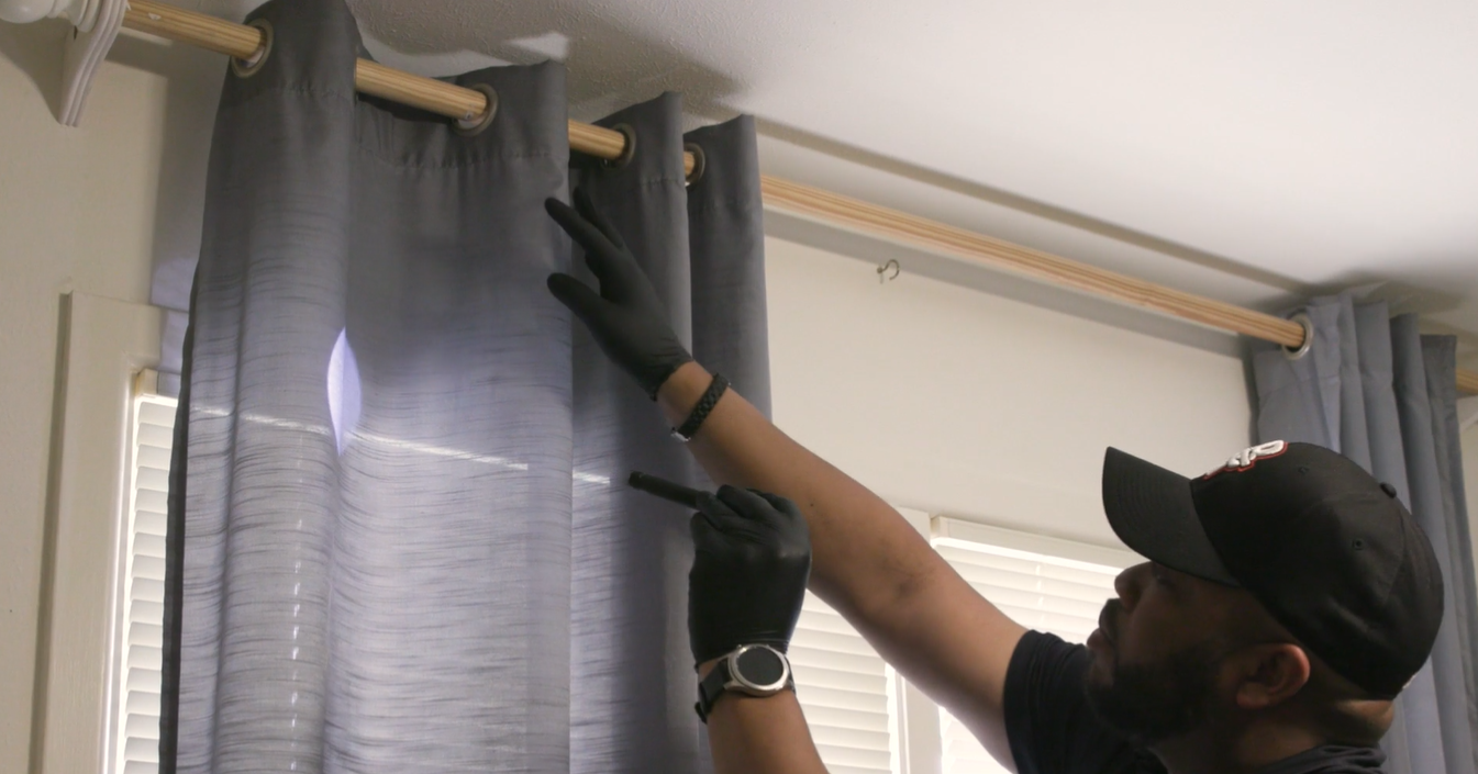 technician inspecting curtains