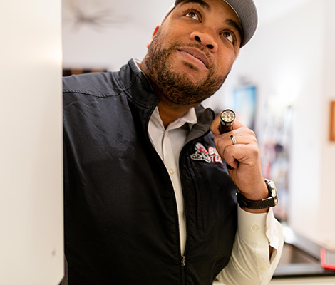 Technician inspecting a cupboard