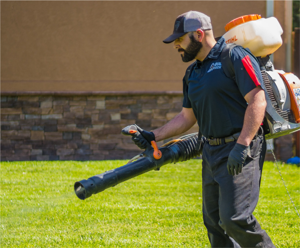 Technician spraying for mosquitos